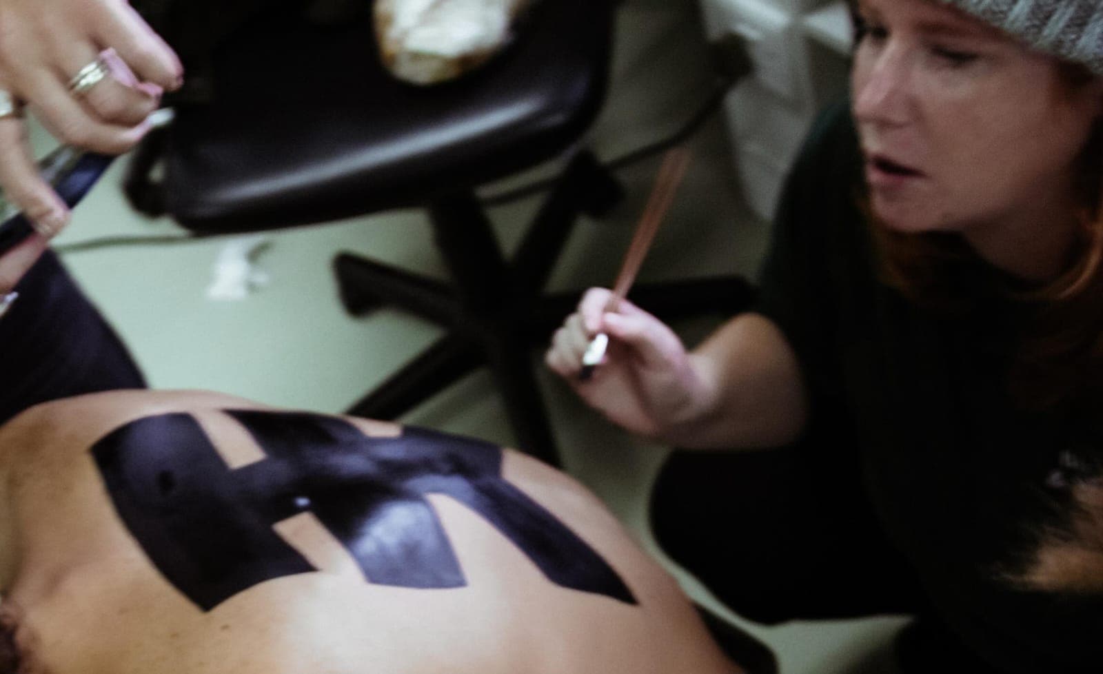 Hunter Kennedy fashion shoot with hand-painted logo body art